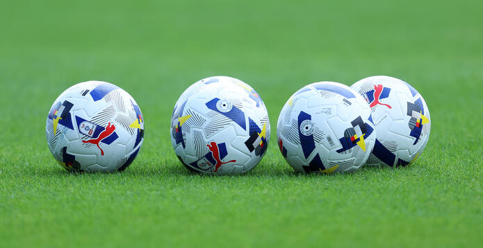 Footballs on pitch