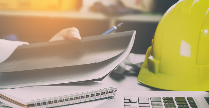 Hard hat on a desk construction contractor disputes