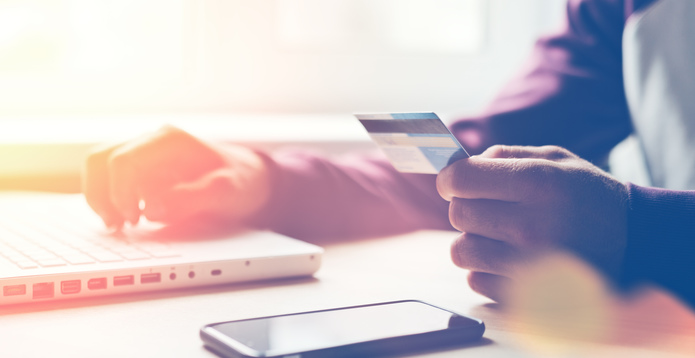 Man with bank card and laptop