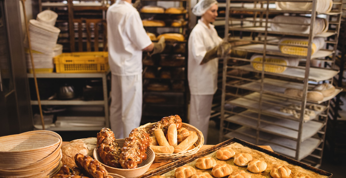 Michetta and sweet food on a table while bakers working