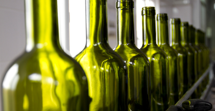 Row of green glass wine bottles card