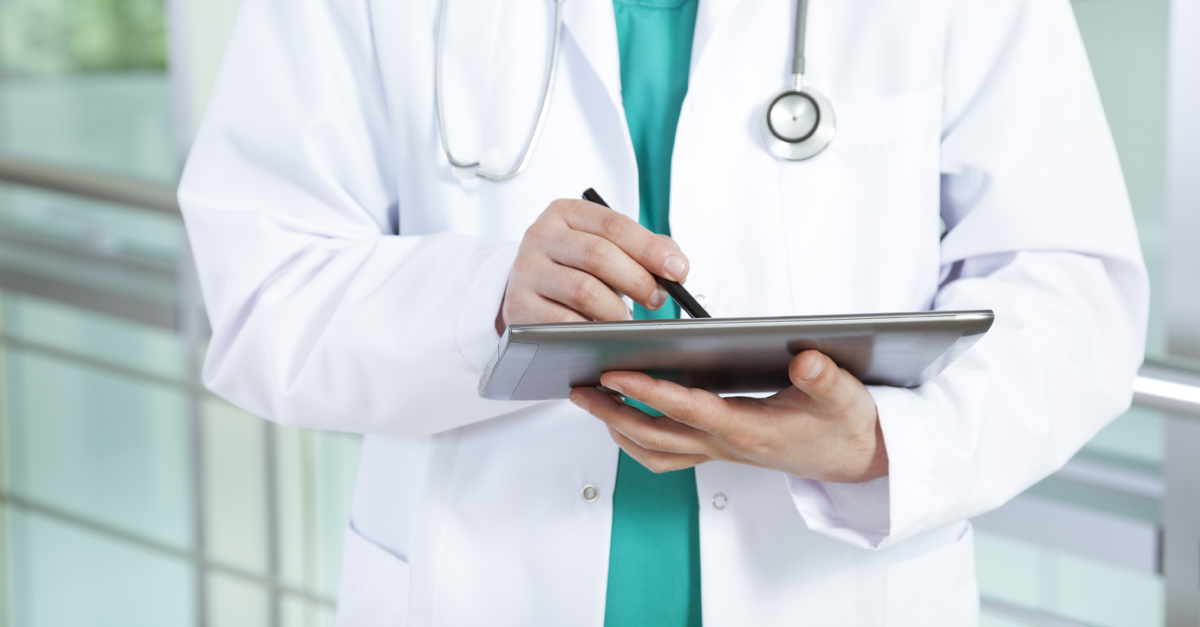 Doctor writing on pad