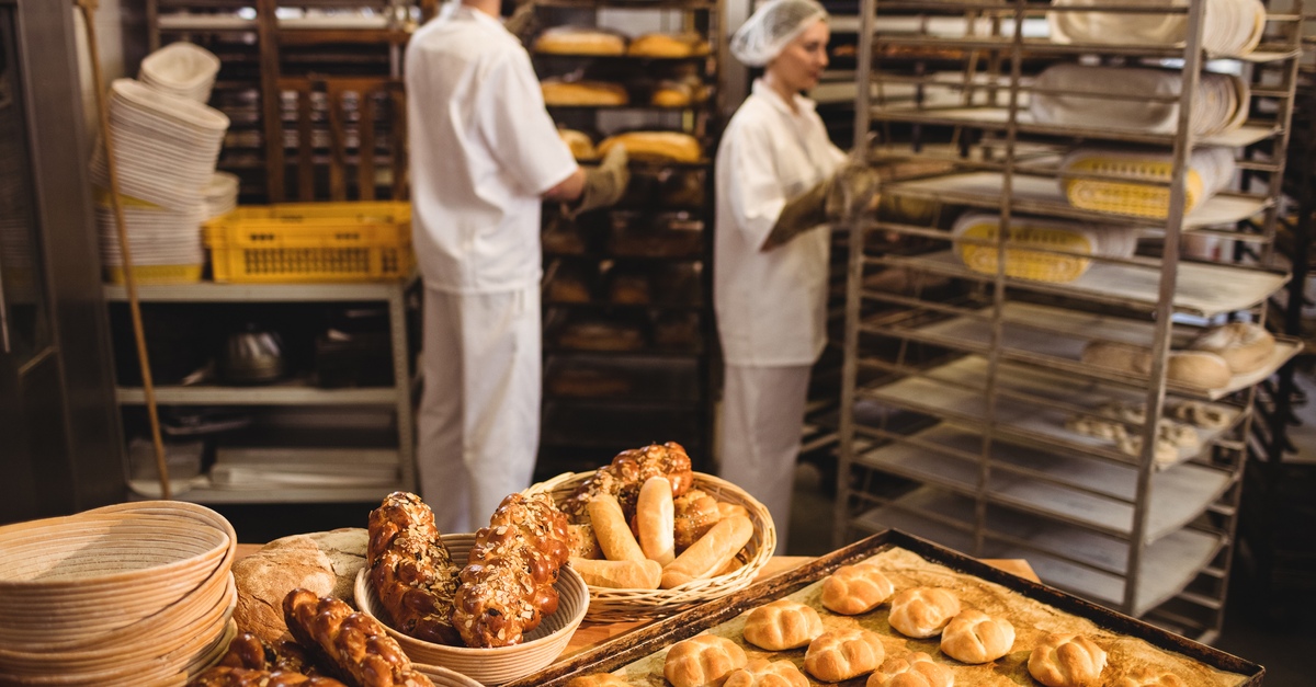 Michetta and sweet food on a table while bakers working